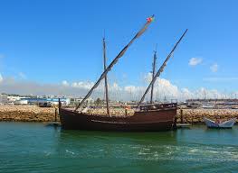 a boat is docked next to a body of water